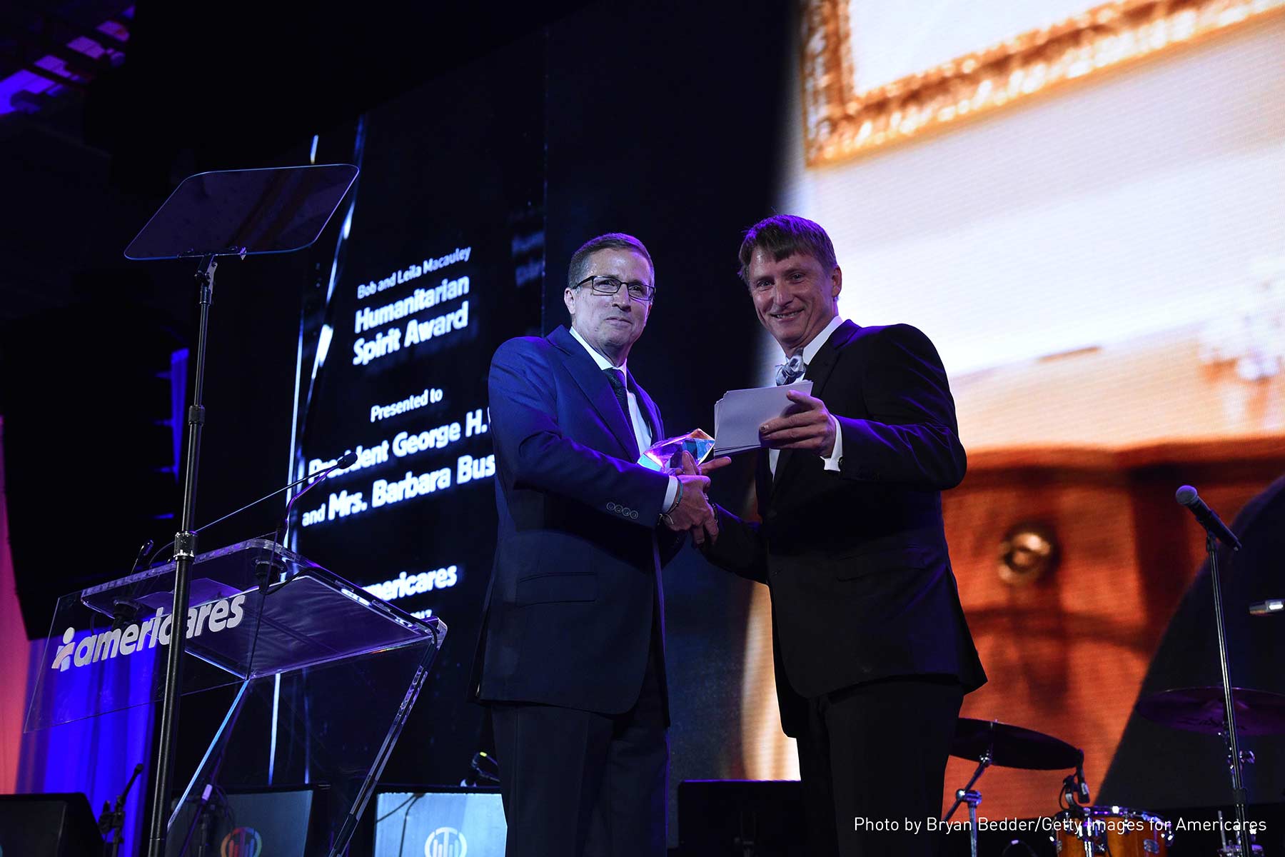 Americares President and CEO Michael J. Nyenhuis (left) presents the Bob and Leila Macauley Humanitarian Spirit Award to Jonathan Bush Jr. 