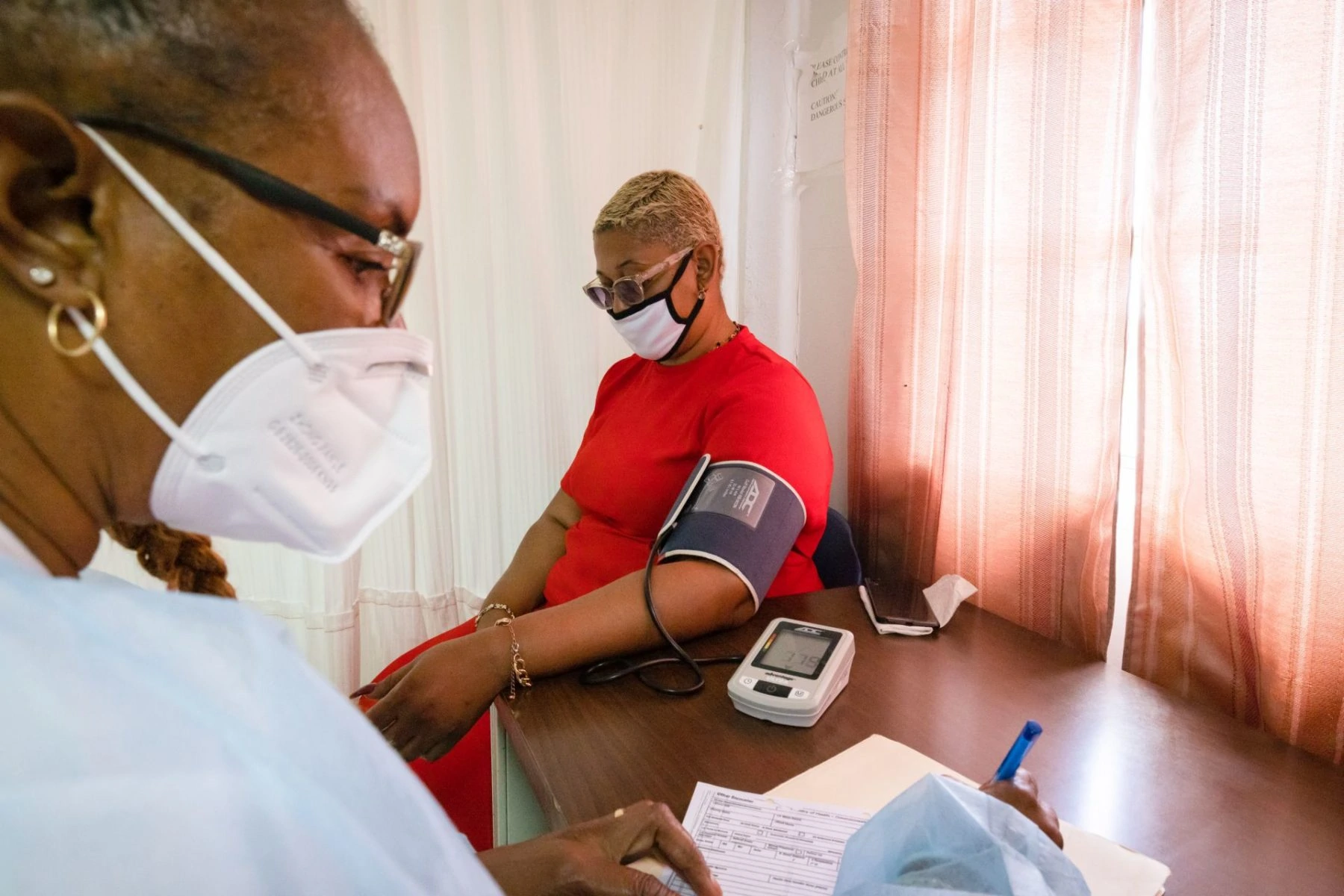 Nurse doing a Blood pressure check on patient at new clinic