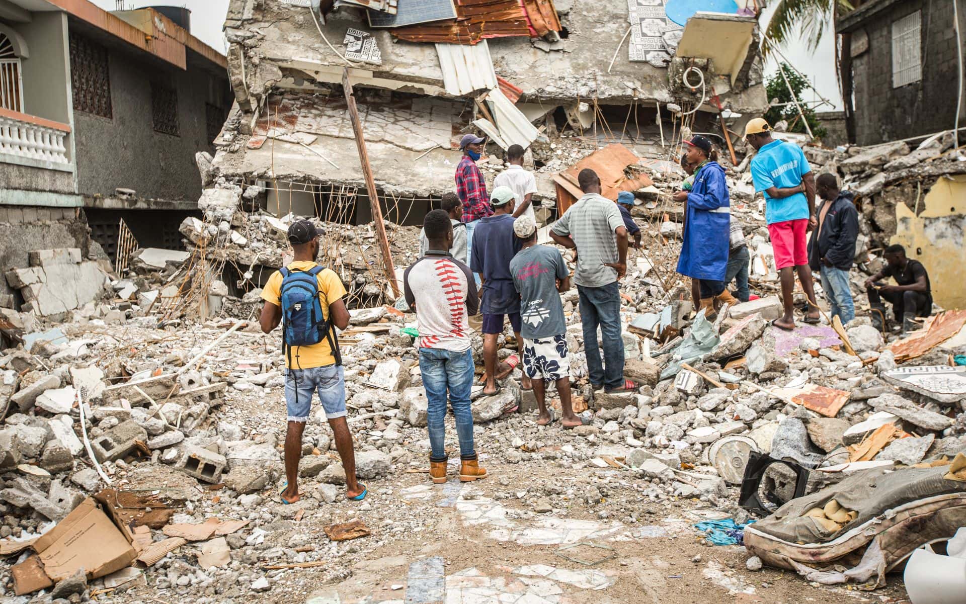 Men work to remove debris after a house collapsed after Saturday's 7.2 earthquake in Les Cayes, Haiti August 17, 2021. (Photo/Orlando Barria)