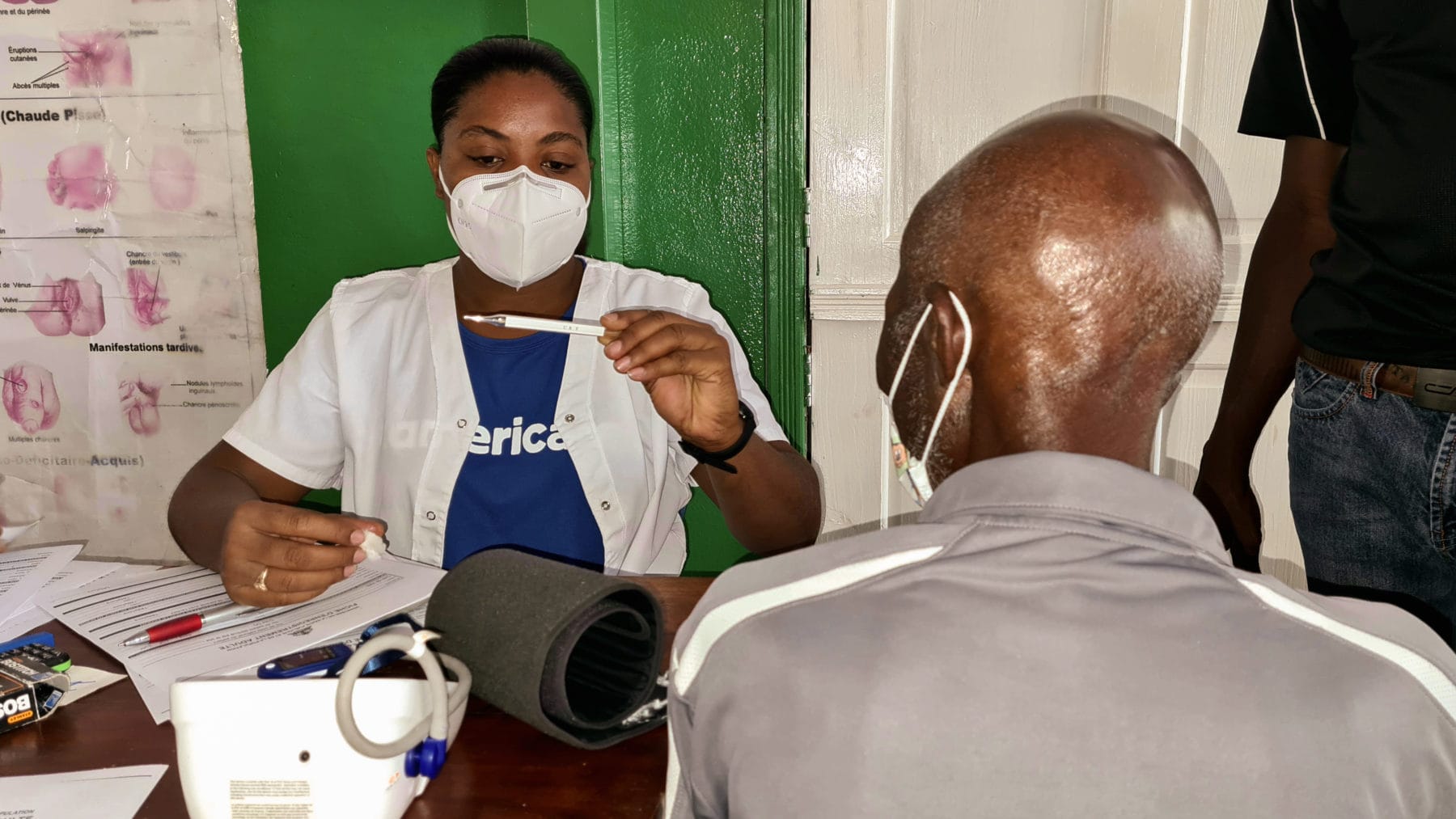 An Americares medical team member checks a patient after Haiti earthquake