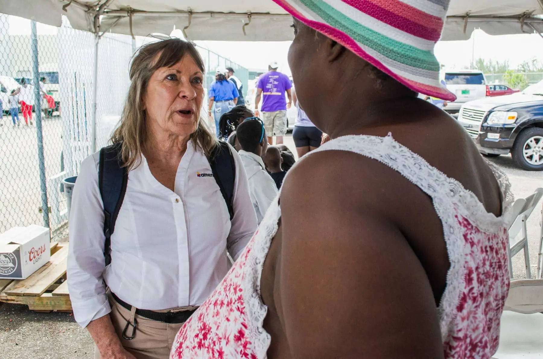 Americares emergency responder Lisa LaDue talks with Hurricane Dorian survivor Juliette