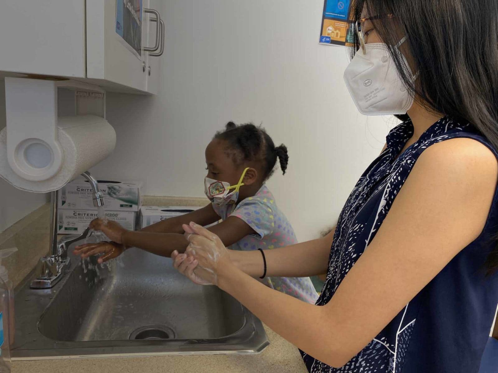 With a mask donated by Americares, Nurse Samatha Tang makes a full safety demonstration at Community of Advanced Practice Nurses clinic in Atlanta, Georgia.