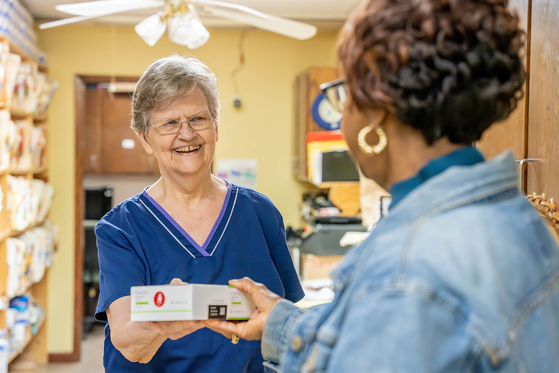 A patient at Eunice Community Health Center in Eunice, La., receives a box of Trulicity donated by Americares and Lilly in April 2023. Photo by Mike Demas/Americares. 