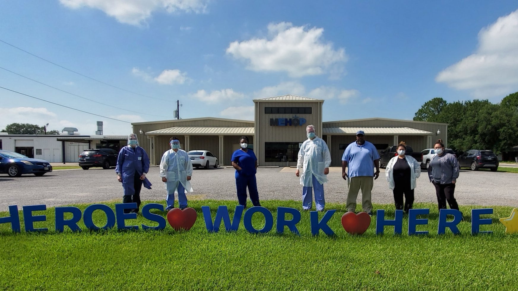 Matagorda health workers in front of a COVID Workers sign