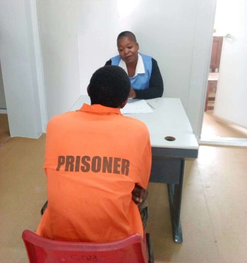 Health worker interviewing a prisoner In Zambia