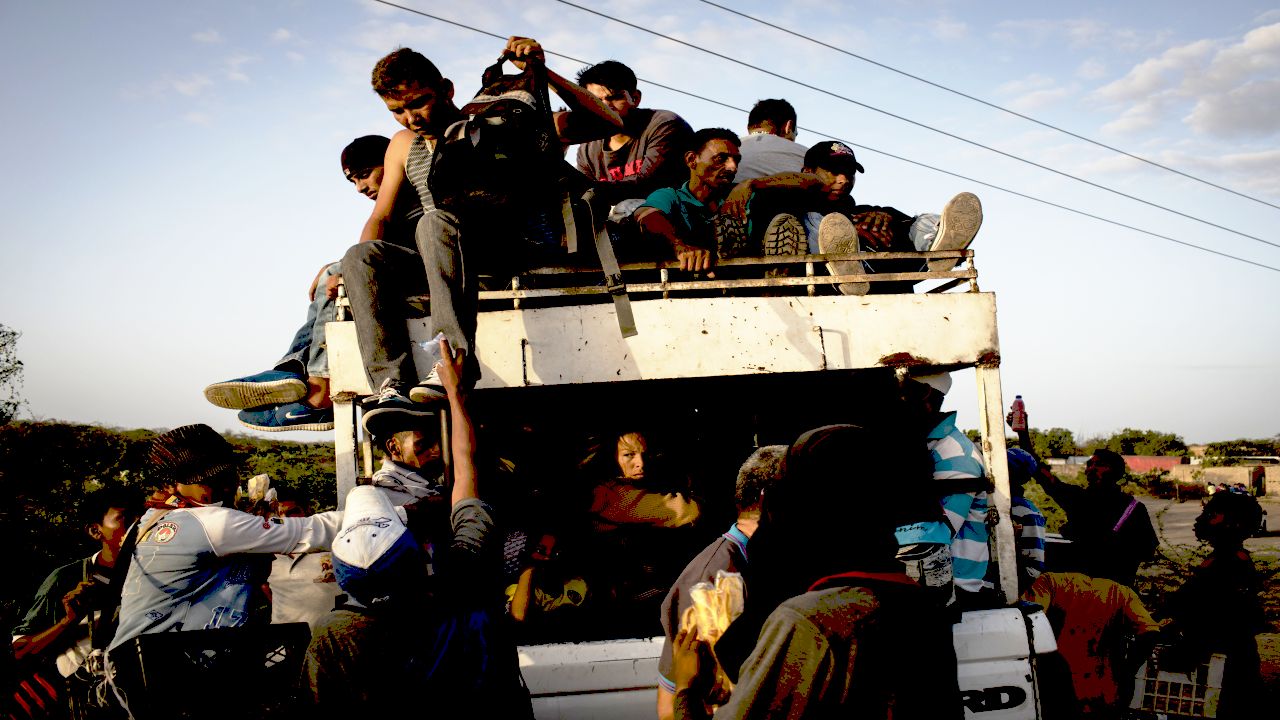 People cross the border between Colombia and Venezuela at the border town of Paraguachon, in La Guajira, passing by illegal shortcuts to avoid passports' controls and the toll's payment. Local Wayuu indigenous children charge a few Bolivares (Venezuelan currency) or a few Colombian pesos to let the cars cross the line.  Americares responds to people’s needs in town by offering them basic medical aids in a recovered area of the old hospital of Maicao, La Guajira, Colombia, on July 5th, 2018. Children and pregnant mother receive the attention first. Since 2015 Venezuelans' mass migration to Colombia progressively increased. After crossing the border migrants start  a long path, often by walk and lasting over three months, to Peru, Chile and Brazil in search of a new life and job opportunities, fleeing their country as President Nicolas Maduro consolidates autocratic power and food and medicine run out due to corruption.  Americares is working on the health emergency response. Photographer: Nicolo Filippo Rosso/Americares