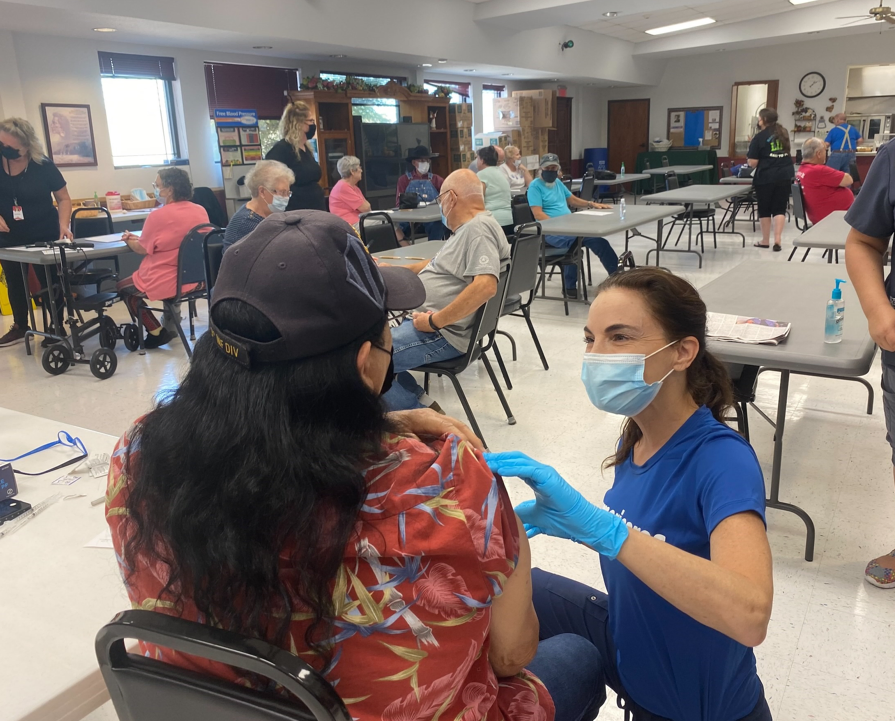 Nurse preparing to administer a vaccine at tribal health center